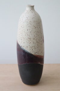 egg and black maroon bottle vase