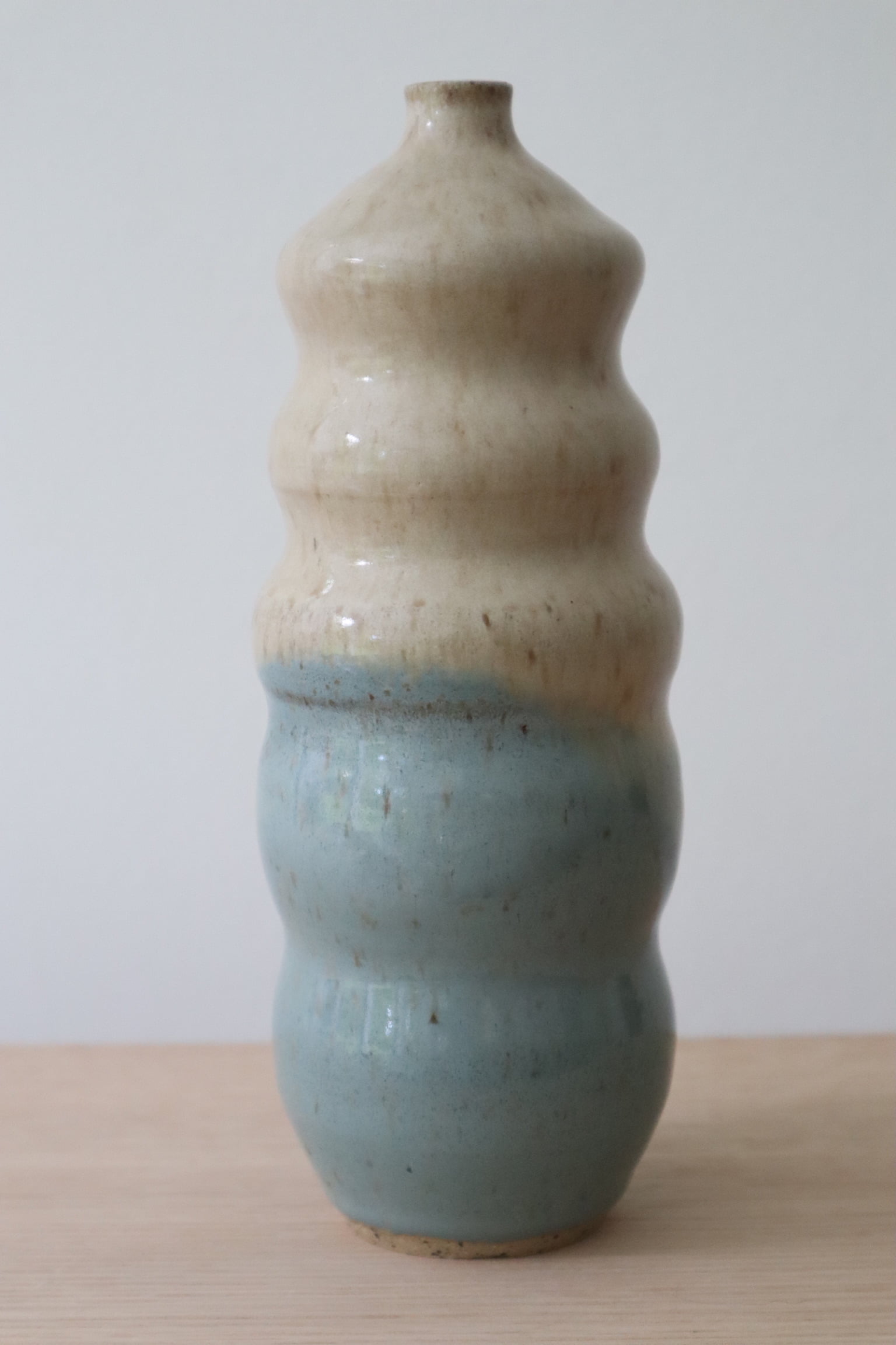 Creamy and blue over speckled clay.